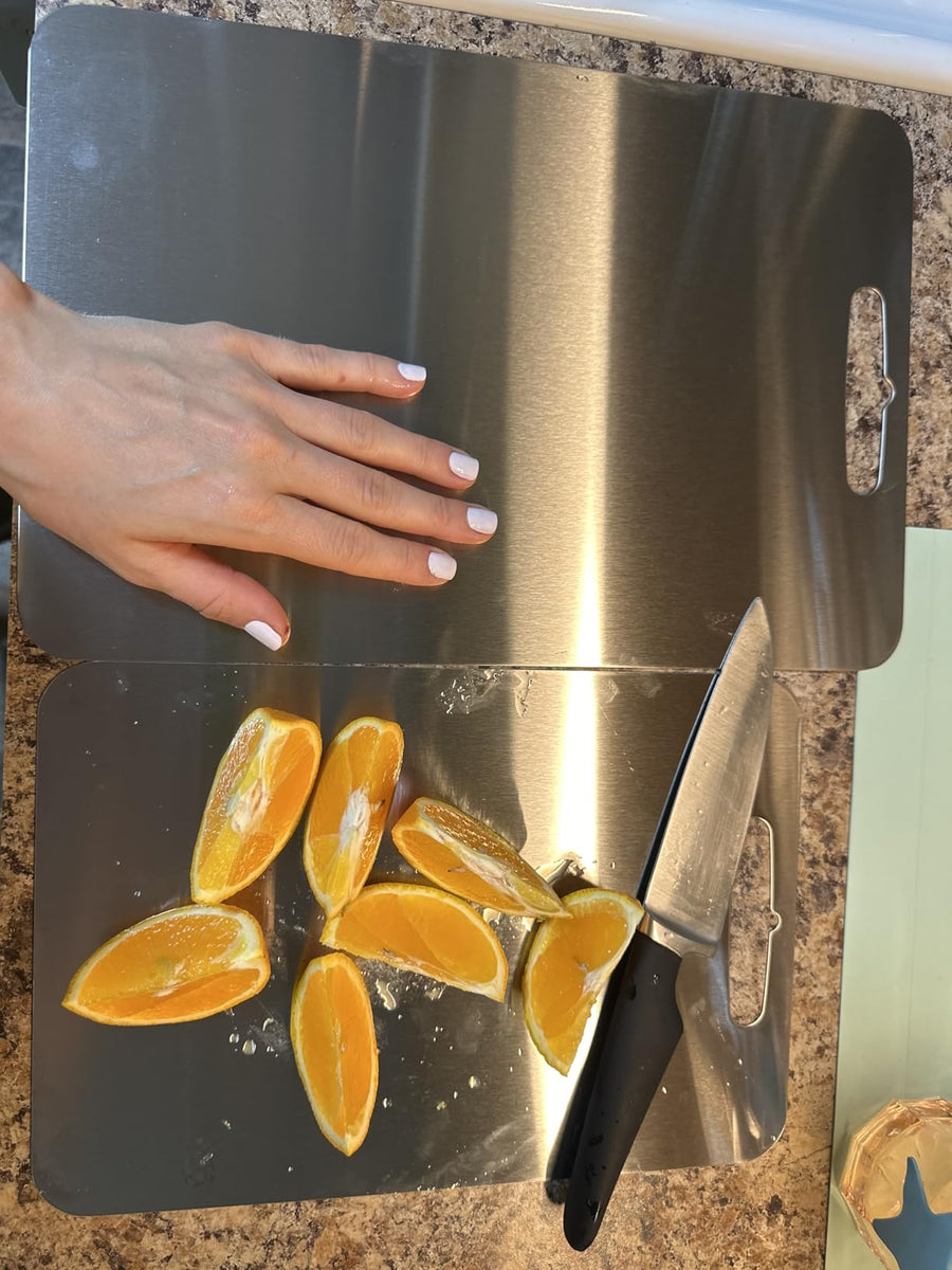 Customer photo: oranges sliced on two ChopChop USA titanium cutting boards
