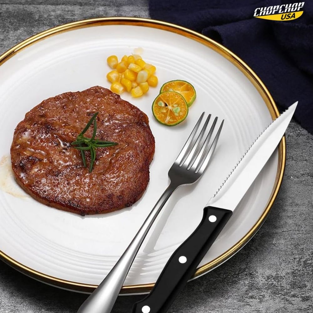 Silver fork and steak knife from the 24-piece set beside a steak