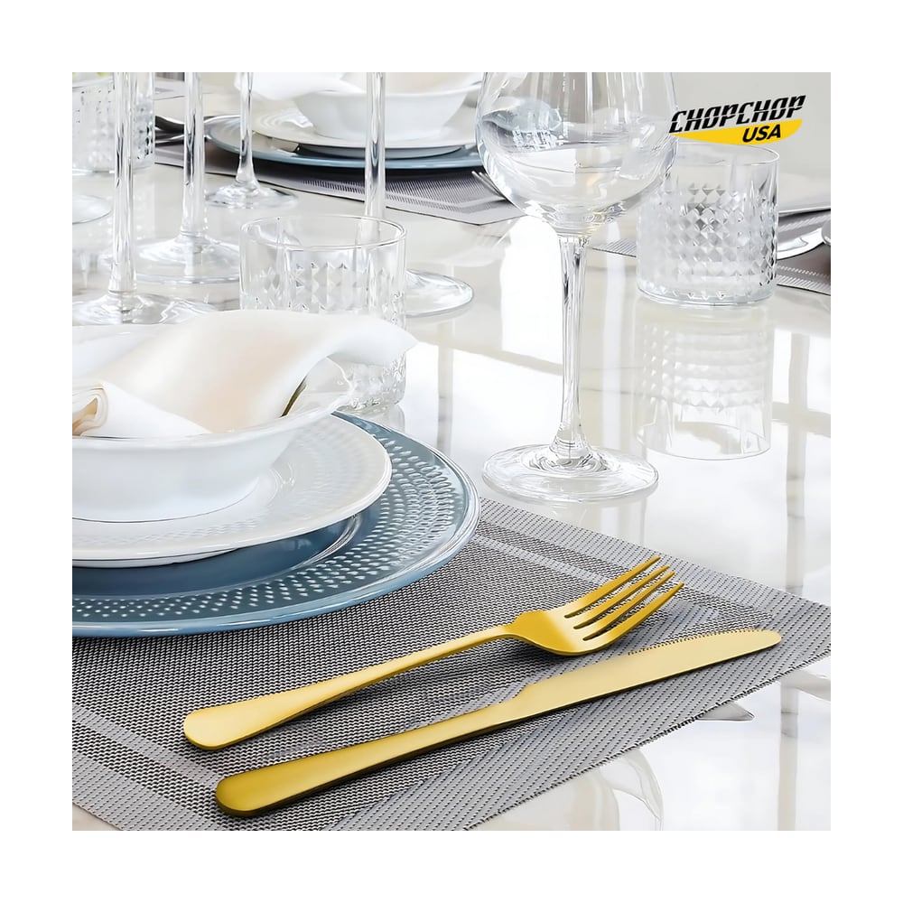 Gold fork and knife on a woven placemat