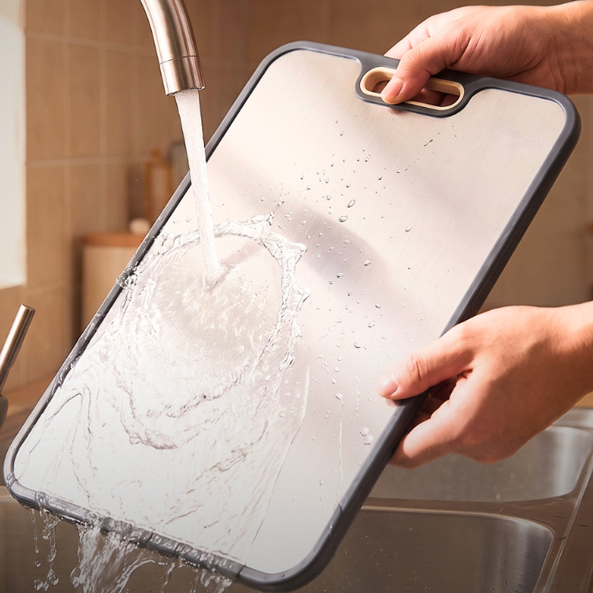Rinsing the titanium side of the ChopChop USA double-sided cutting board under the kitchen tap