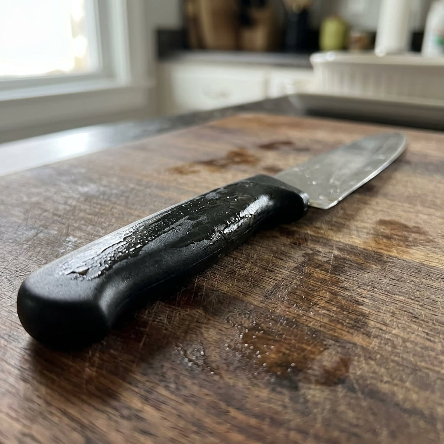 Cheap kitchen knife with a greasy, slippery plastic handle