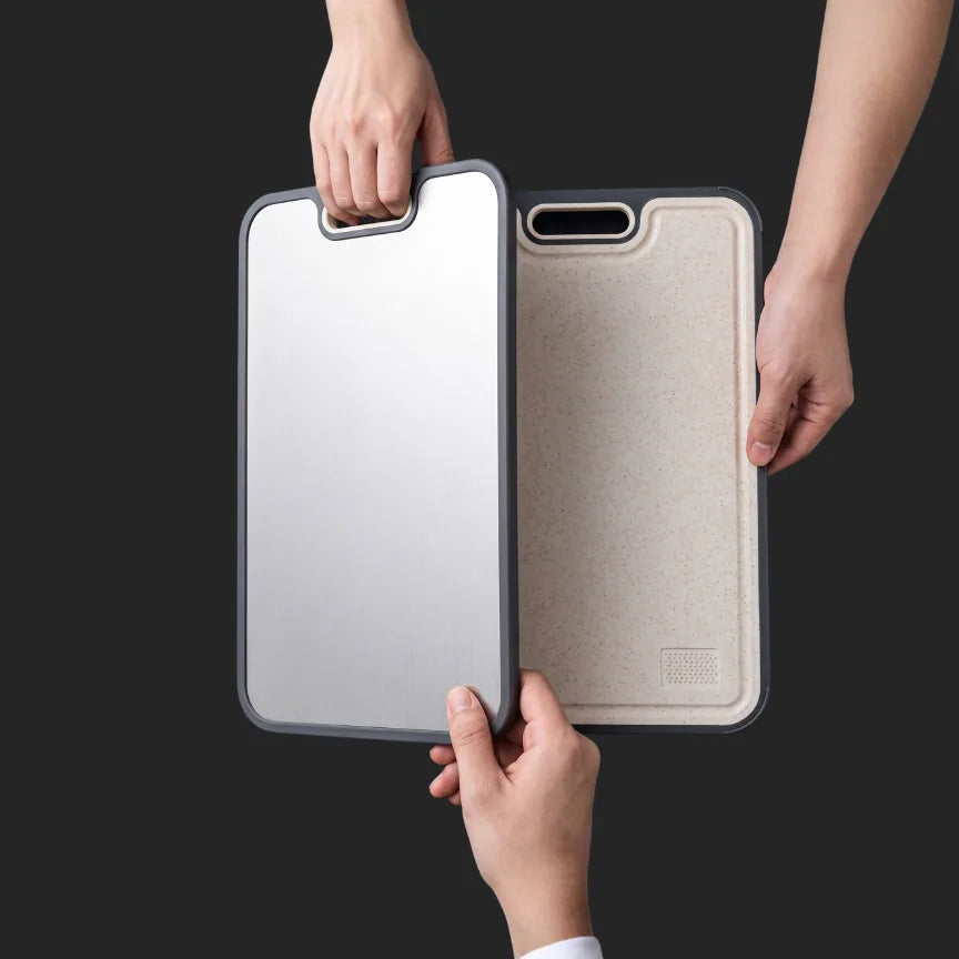 Hands holding the titanium side and the wheat-fiber side of the board