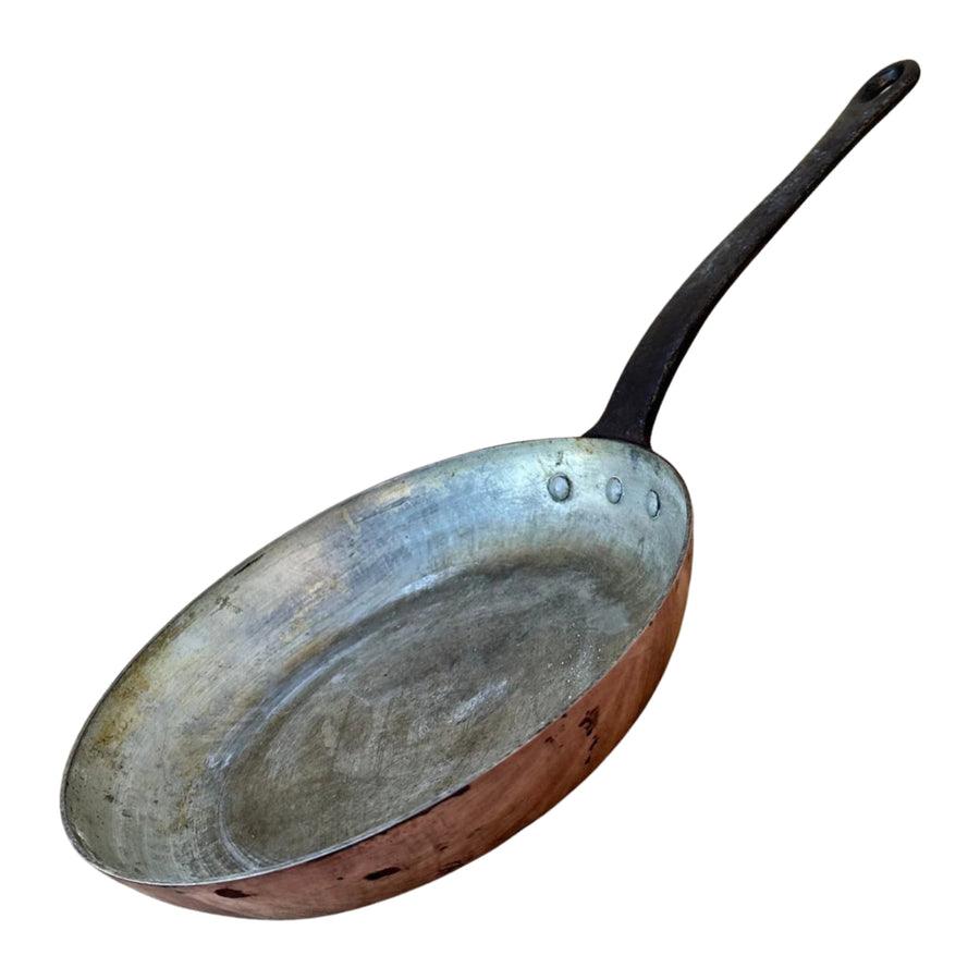 Old worn aluminum frying pan with a dull, discolored surface