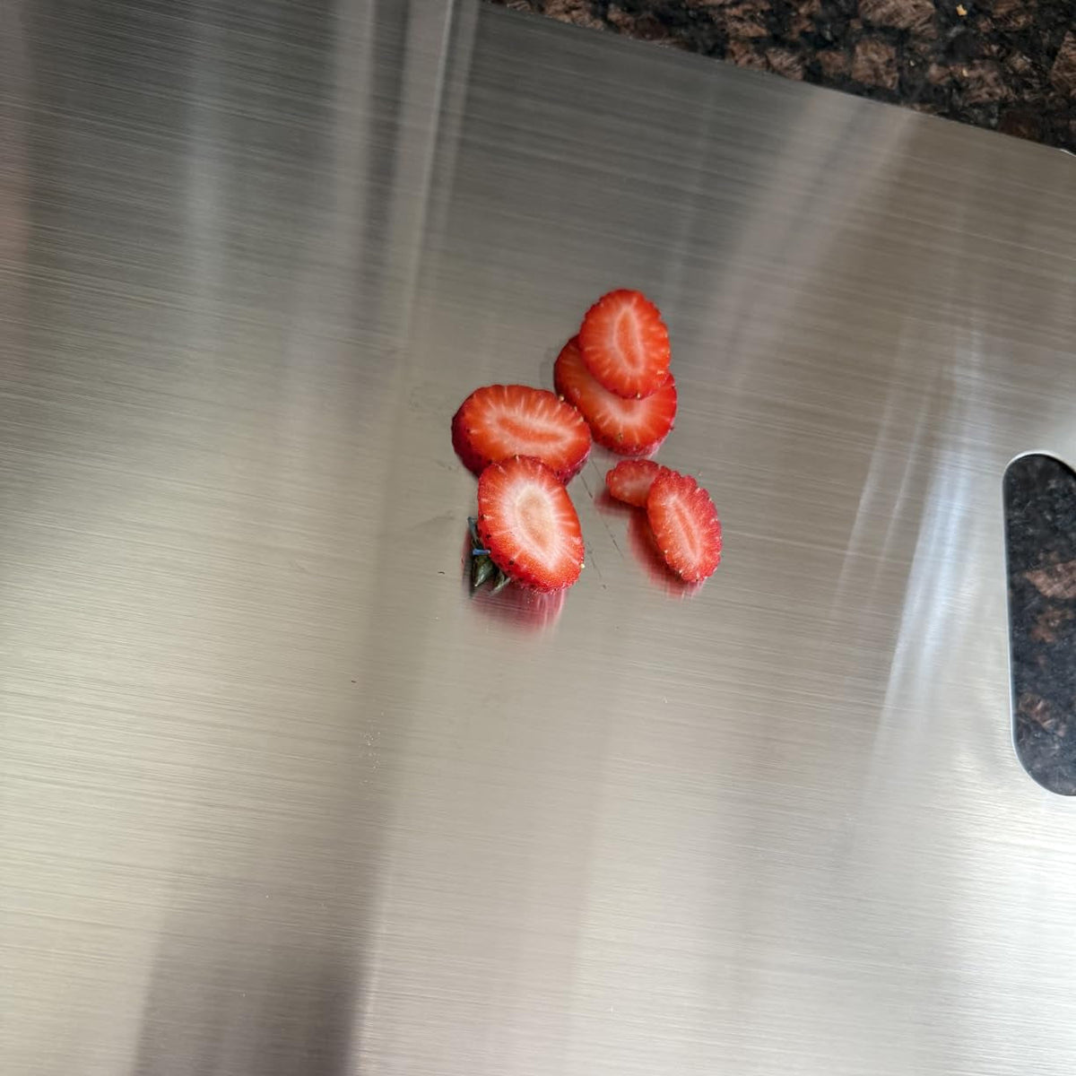 Sliced strawberries on the ChopChop USA pure titanium cutting board - non-reactive with acidic fruit