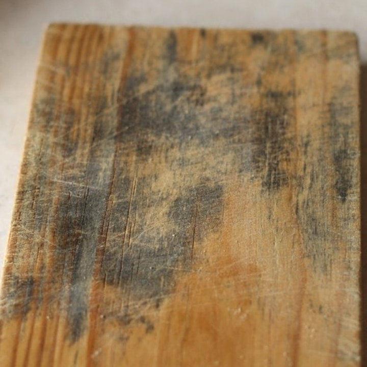 Old wooden cutting board with black mold and deep knife scratches - why wood cutting boards trap bacteria